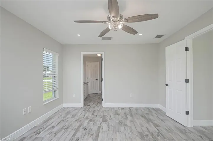 Spare room featuring ceiling fan and light hardwood / wood-style floors