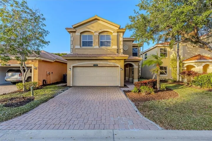 Mediterranean / spanish-style home featuring stucco siding, decorative driveway, an attached garage, and a tile roof