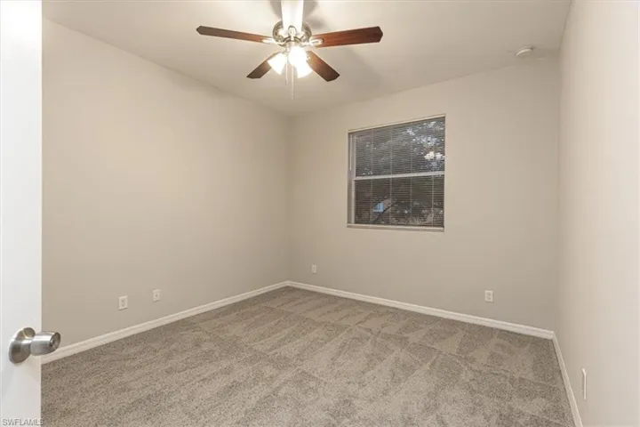 Empty room with carpet and ceiling fan