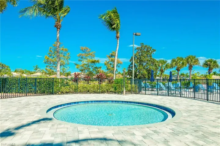 Kiddy pool for children with safety fence at amenity, adjacent to large resort style pool