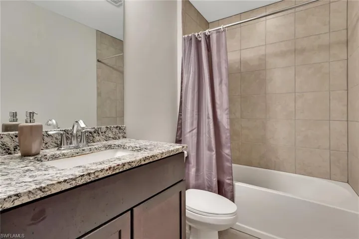 Full bath featuring shower / bathtub combination with curtain and vanity