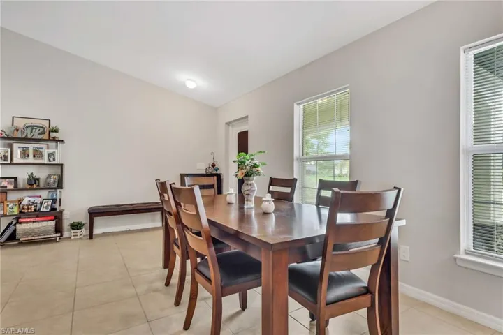 Dining area with light tile patterned floors and baseboards