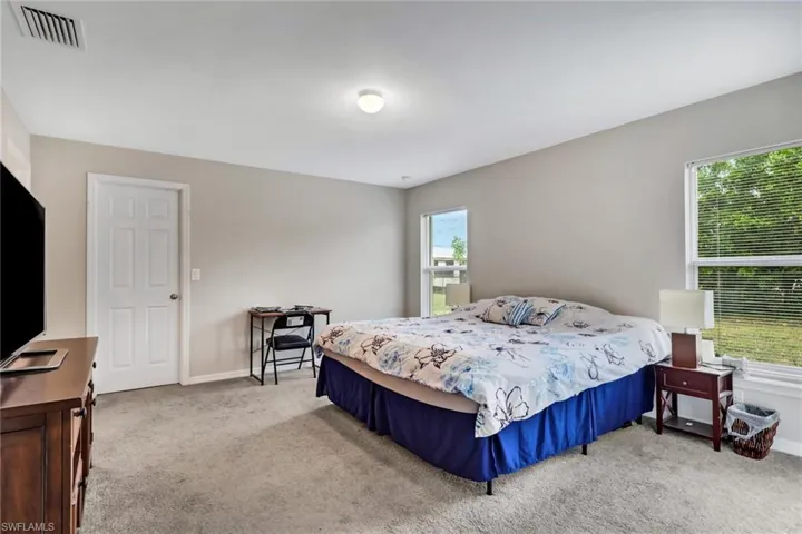 Bedroom with light colored carpet