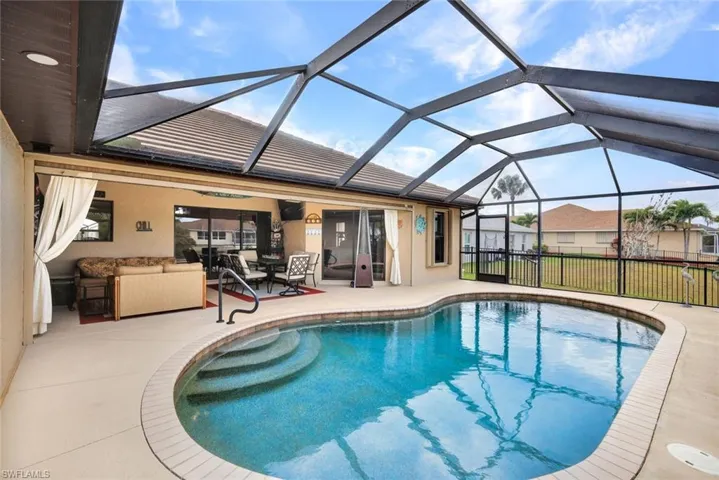 Outdoor pool featuring a lanai, a sunroom, and a patio area