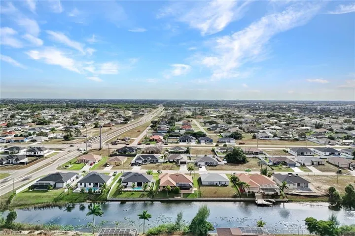 Aerial perspective of suburban area featuring a large body of water