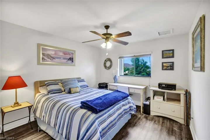 Bedroom featuring a ceiling fan and dark wood-style floors