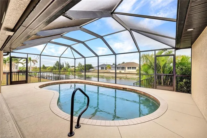Swimming pool featuring a water view, a lanai, a sunroom, a patio, and a residential view