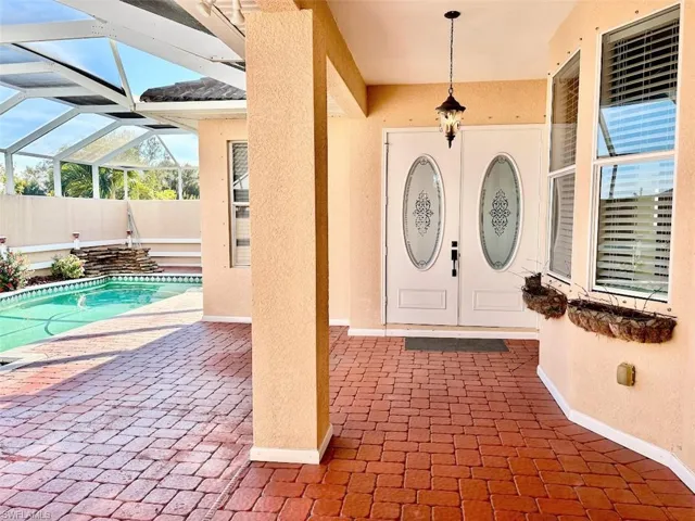 Doorway to property featuring a fenced in pool and a patio