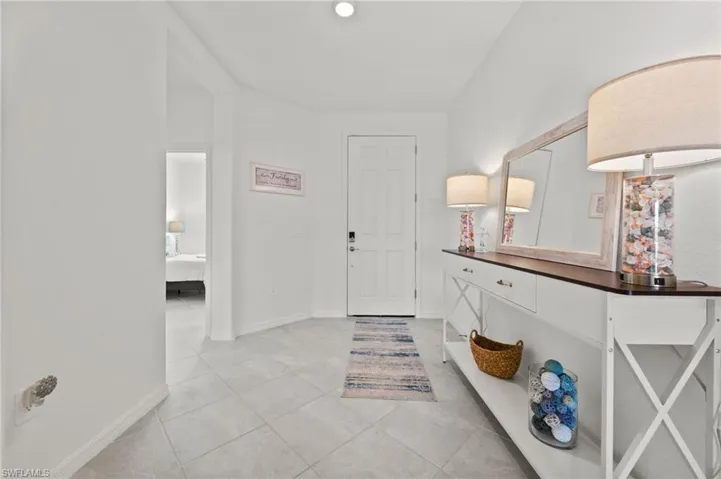 Entry hall looking toward front door with 3rd bedroom to the left
