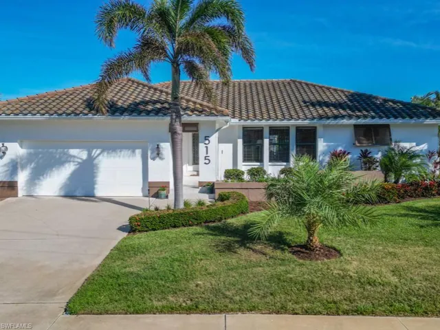 View of front of home featuring a garage and a front lawn