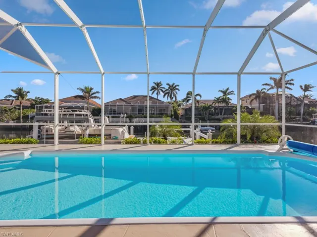 View of swimming pool featuring a lanai