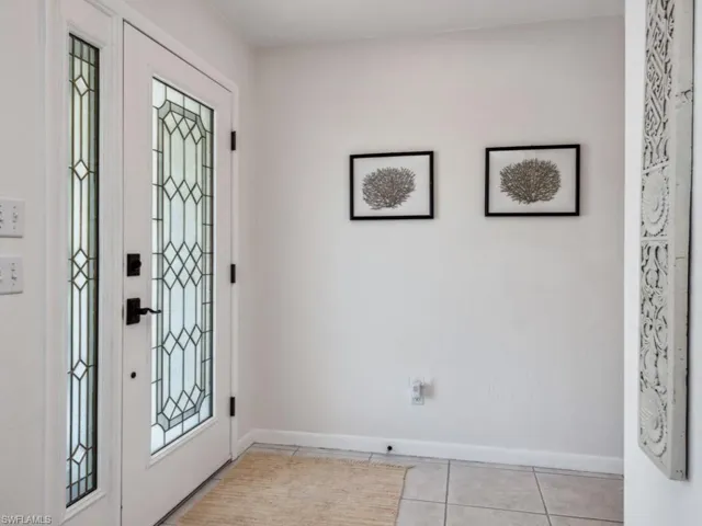 Foyer entrance featuring light tile patterned floors