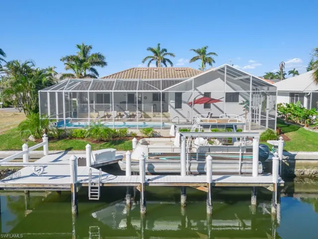 Dock area featuring glass enclosure and a water view