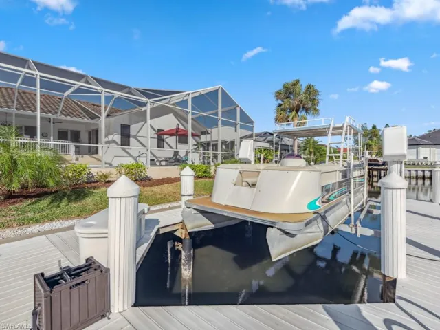 Dock area featuring a water view and glass enclosure