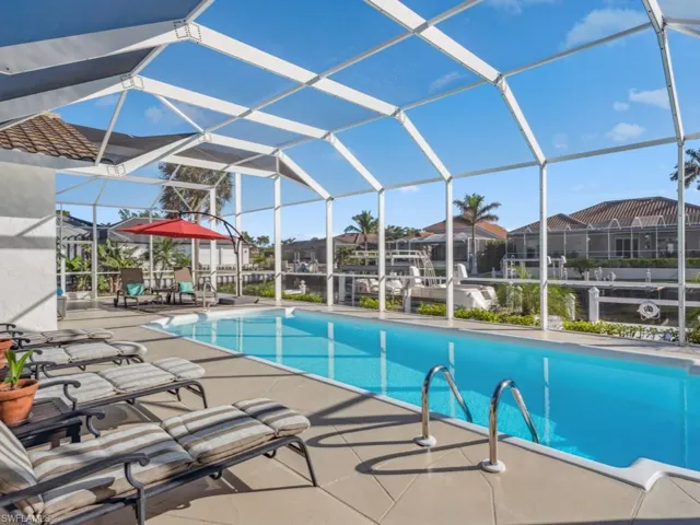 View of pool with a patio area and a lanai