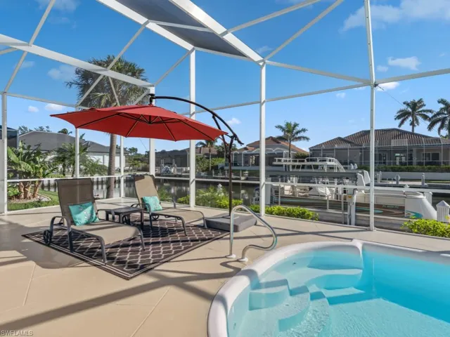 View of pool featuring a lanai, a patio area, and a water view