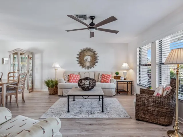 Living room with light hardwood / wood-style floors and ceiling fan