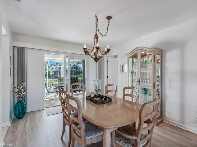 Dining room featuring an inviting chandelier and light hardwood / wood-style flooring