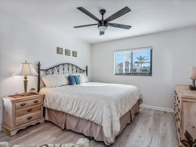Bedroom with ceiling fan and light hardwood / wood-style floors