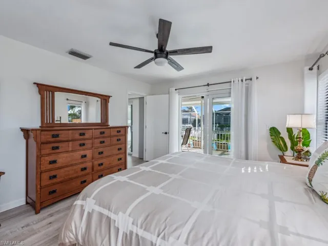 Bedroom with ceiling fan, access to exterior, and light wood-type flooring