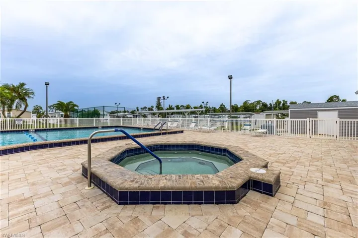 Community pool featuring a hot tub and a patio area