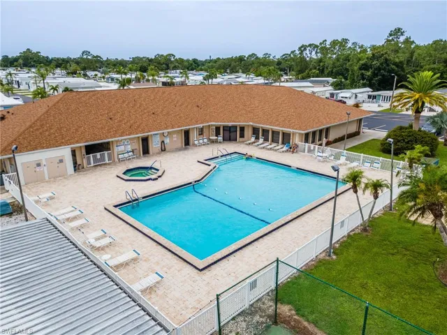 Community pool with a hot tub and a patio area