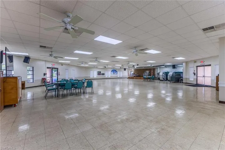 Miscellaneous room with a ceiling fan and a paneled ceiling