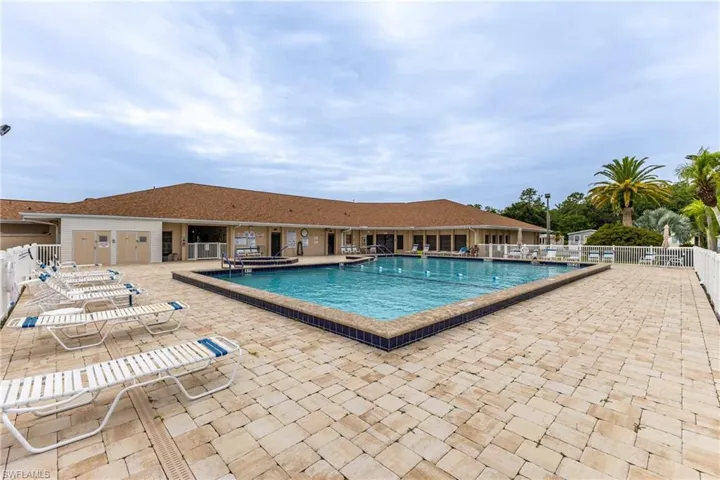 Community pool with a patio