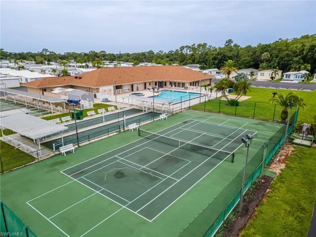View of tennis court featuring a community pool