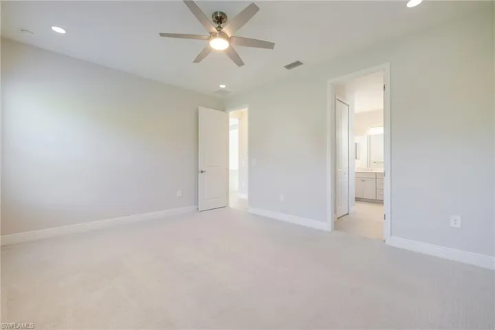 Unfurnished bedroom featuring recessed lighting, light colored carpet, and a ceiling fan