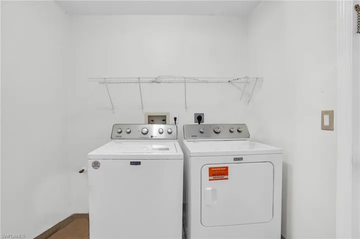 Clothes washing area featuring separate washer and dryer