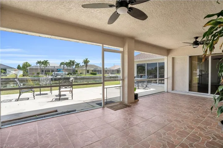Unfurnished sunroom with ceiling fan