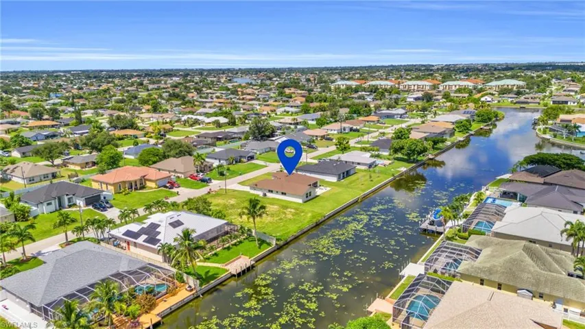 Birds eye view of property with a water view