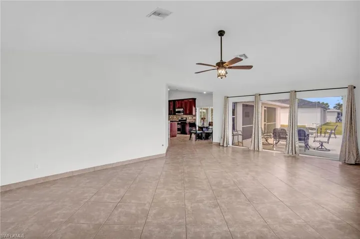 Tiled empty room featuring ceiling fan