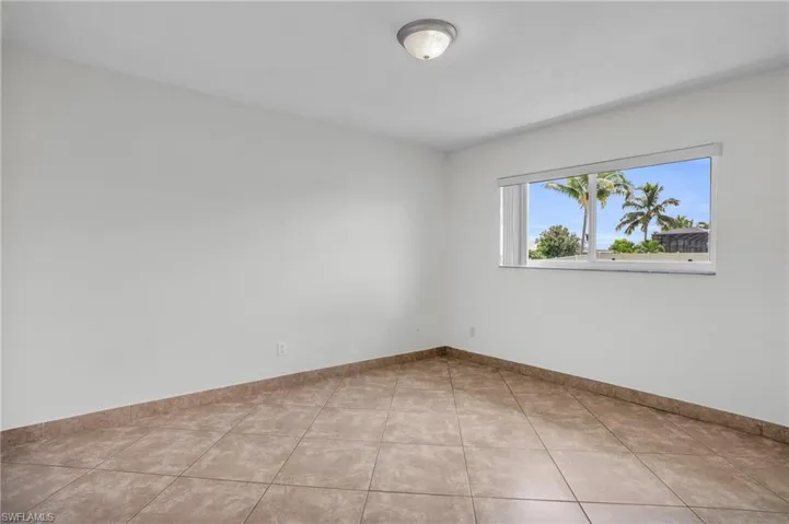 Spare room with light tile patterned flooring