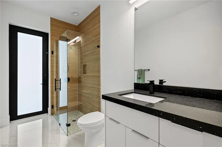 Full bath with a stall shower and vanity