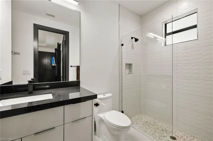 Full bathroom with walk in shower and vanity