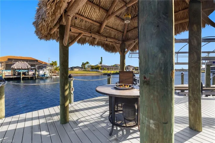 Dock area featuring a water view and boat lift