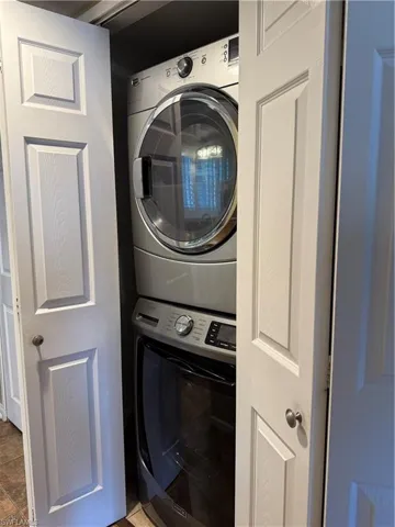 Washroom with stacked washer / drying machine