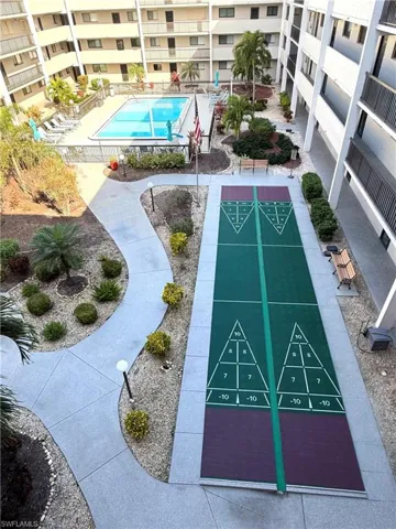 Surrounding community with shuffleboard and a pool