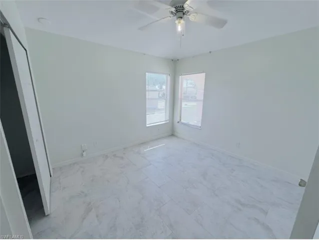 Unfurnished bedroom with a closet and a ceiling fan