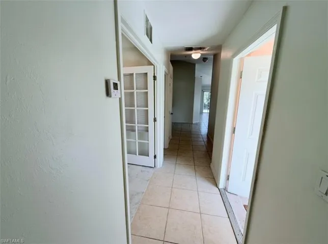 Hall with light tile patterned floors