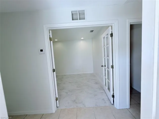 Corridor featuring recessed lighting and baseboards