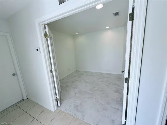 Hallway with recessed lighting and baseboards