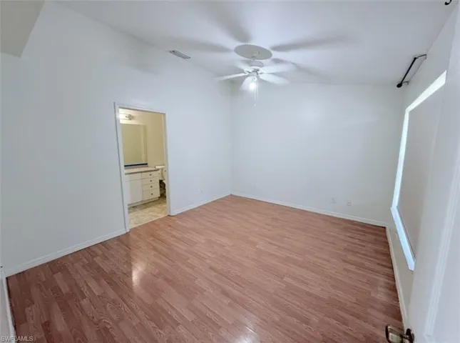Unfurnished bedroom with light wood-style floors, a ceiling fan, and ensuite bathroom