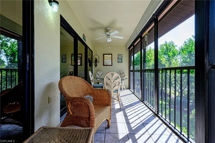 Sunroom / solarium featuring ceiling fan