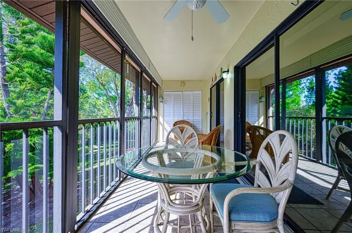 Sunroom / solarium featuring ceiling fan