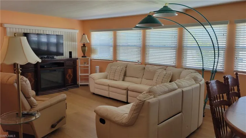 Living room with light wood-style vinyl flooring