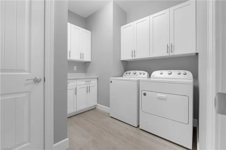 White shaker-style custom cabinetry and countertop to match the kitchen. 16160 Bluestem Ln. Babcock Ranch, FL 33982