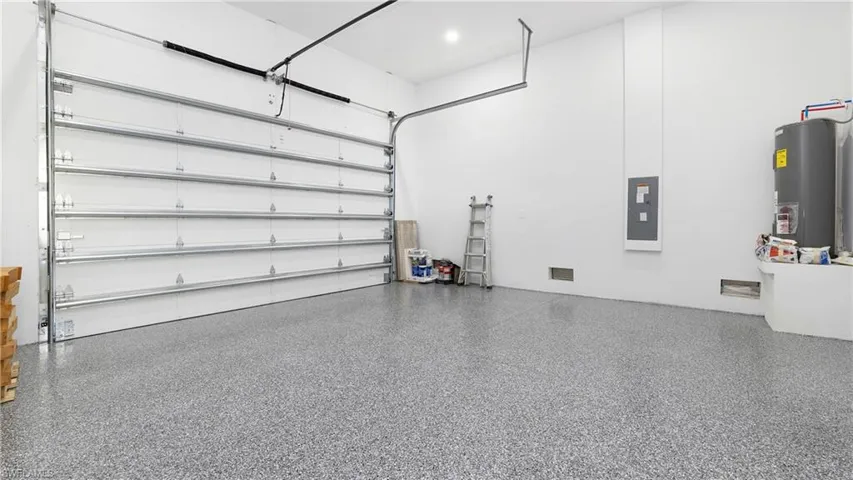 Garage with electric water heater and electric panel